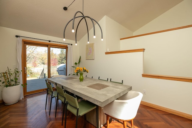 dining room with lofted ceiling and baseboards