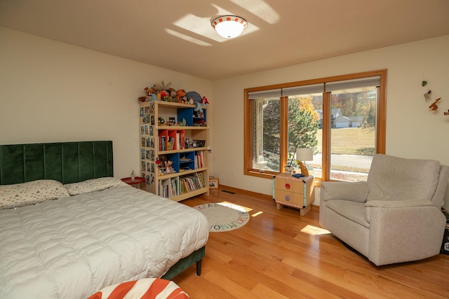 bedroom with visible vents and wood finished floors