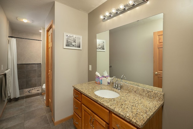 full bath with toilet, tiled shower, tile patterned floors, and vanity