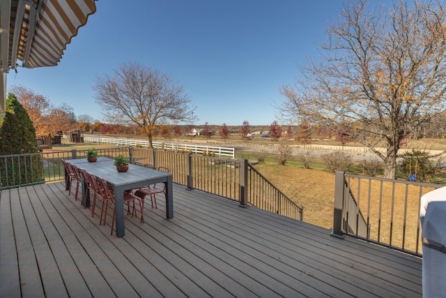 wooden terrace with a yard and outdoor dining space