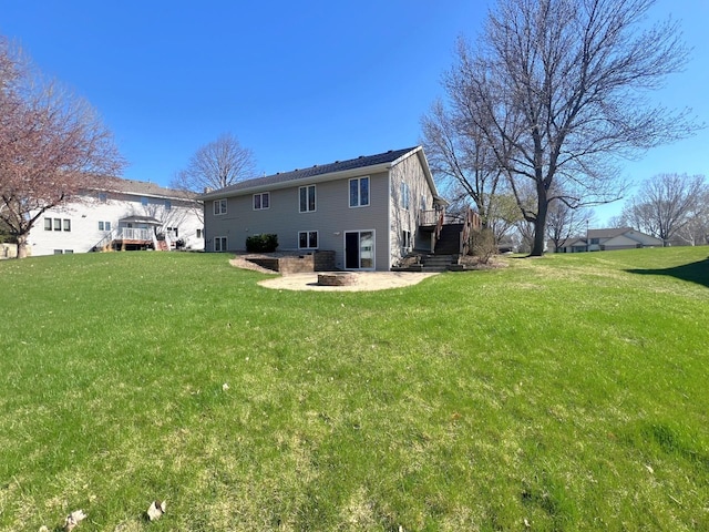 rear view of property with stairs, a deck, and a yard