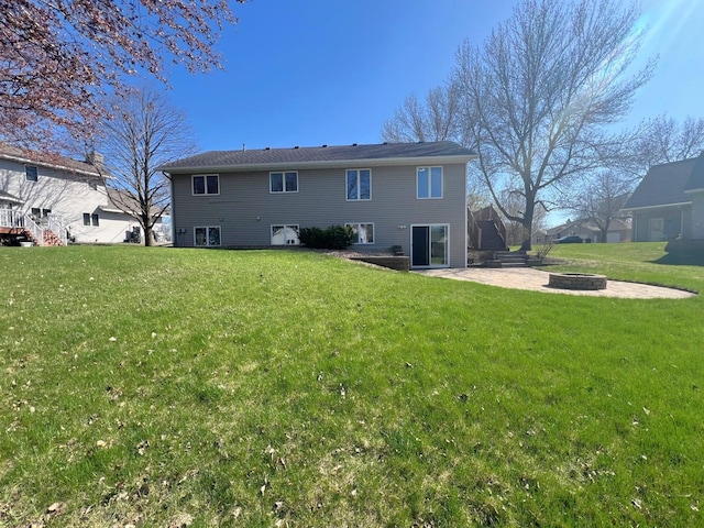 back of property featuring a fire pit, a patio, and a yard