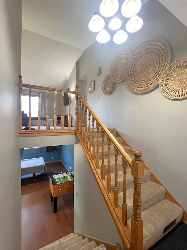 stairs featuring lofted ceiling and baseboards