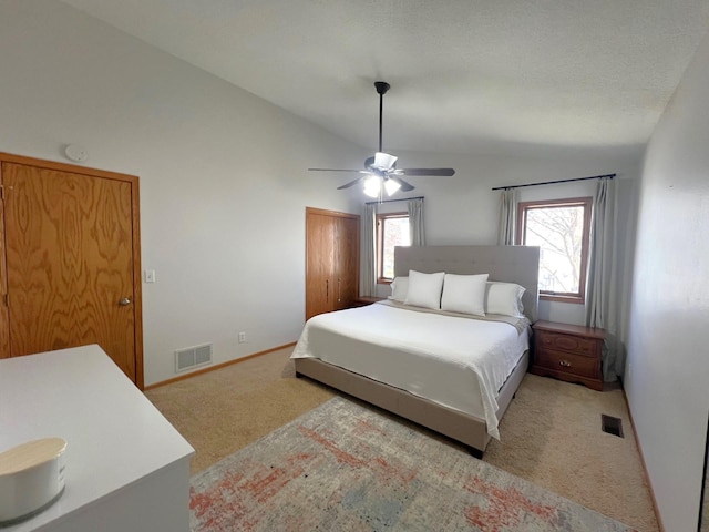bedroom featuring vaulted ceiling, carpet, a ceiling fan, a closet, and baseboards