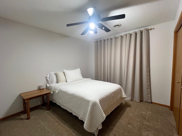 carpeted bedroom featuring baseboards and a ceiling fan