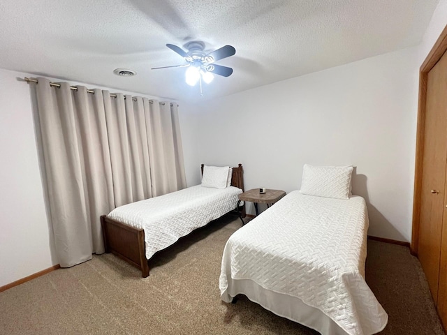 bedroom featuring carpet, a ceiling fan, baseboards, and a textured ceiling