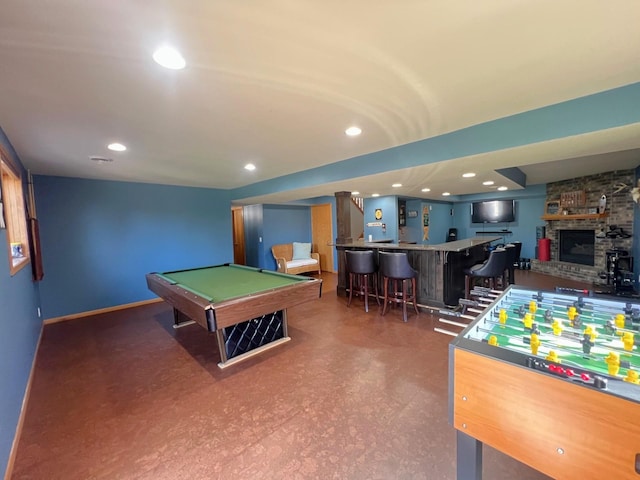 playroom featuring billiards table, a community bar, recessed lighting, and a stone fireplace