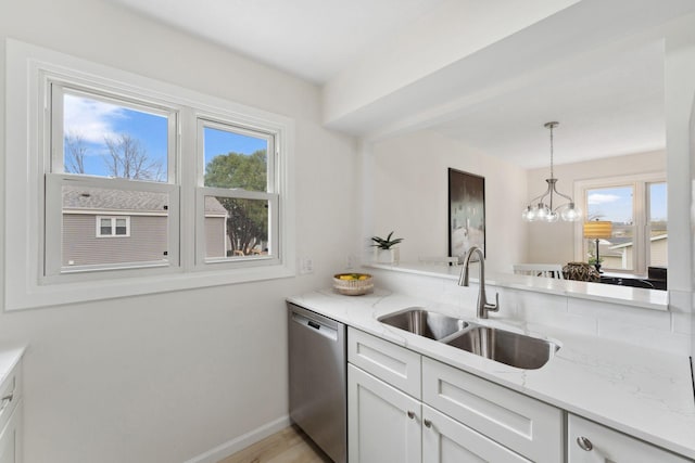 304 Lakeview Ave, Long Lake, MN 55356 - kitchen with light stone countertops, stainless steel dishwasher, hanging light fixtures, a sink, and white cabinetry