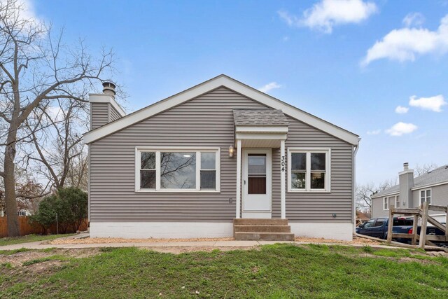 304 Lakeview Ave, Long Lake, MN 55356 - view of front facade with entry steps, a chimney, and a front yard
