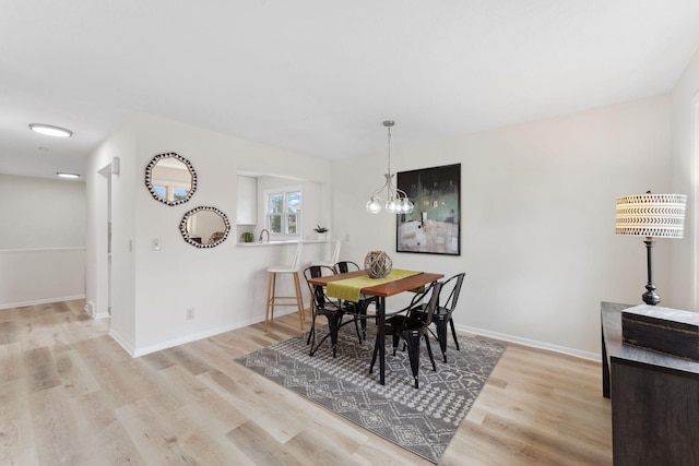 304 Lakeview Ave, Long Lake, MN 55356 - dining room with wood finished floors, baseboards, and a notable chandelier