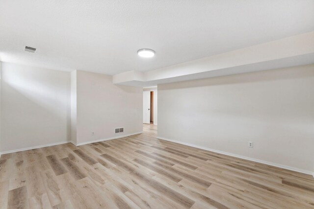 304 Lakeview Ave, Long Lake, MN 55356 - finished below grade area with light wood-type flooring, visible vents, and baseboards