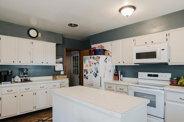 kitchen with white appliances, white cabinetry, and light countertops