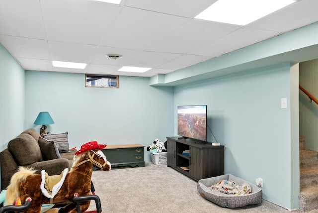 recreation room featuring carpet flooring and a drop ceiling