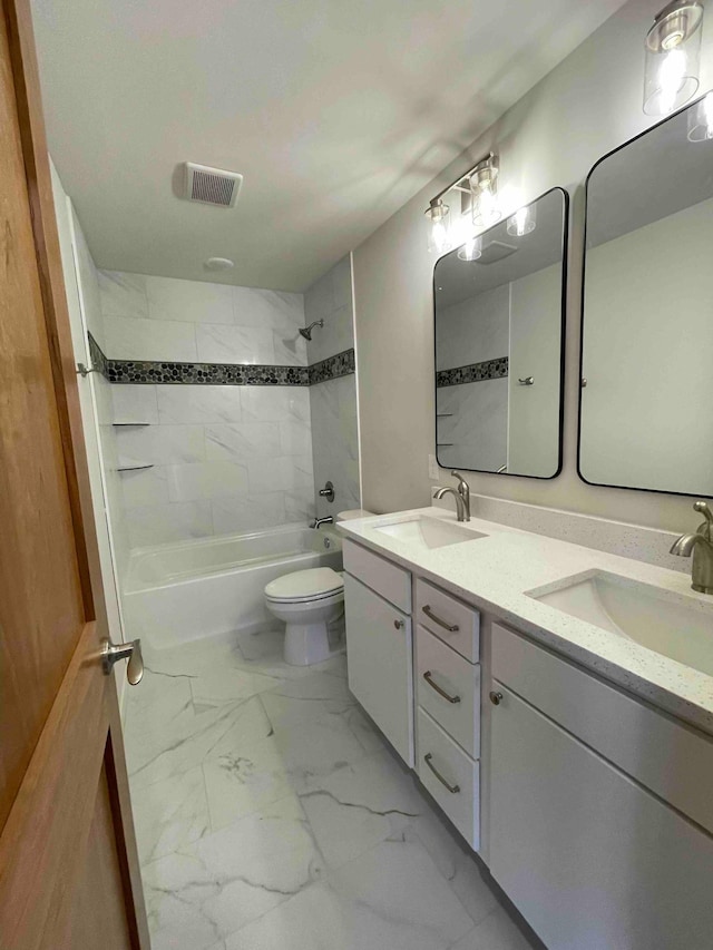 bathroom with visible vents, a sink, marble finish floor, and shower / tub combination