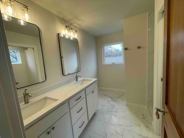 full bathroom with plenty of natural light, a sink, and marble finish floor