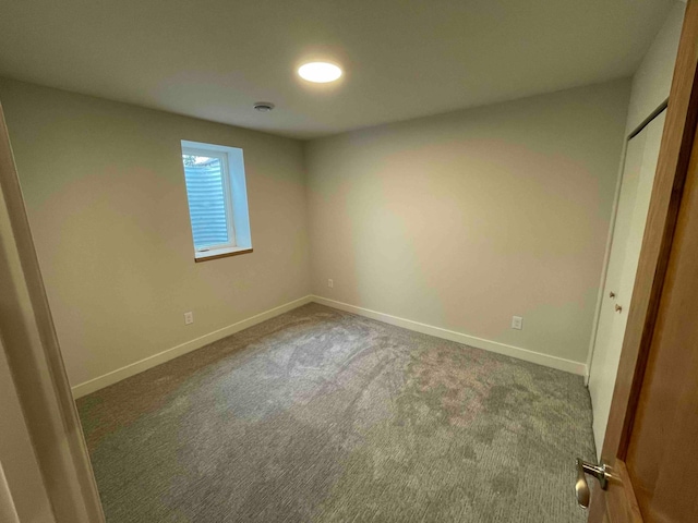 unfurnished bedroom with carpet flooring, baseboards, and a closet