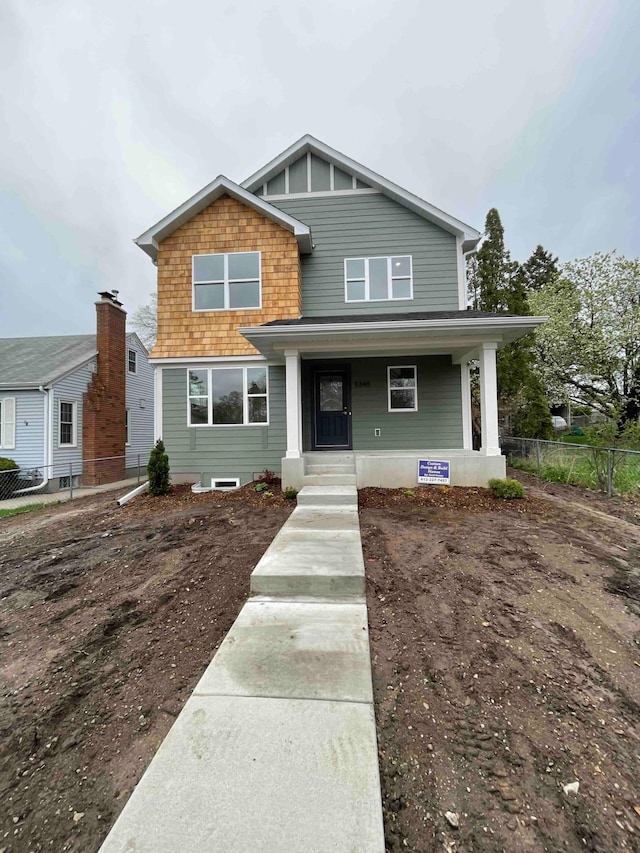 view of front of property with fence and covered porch