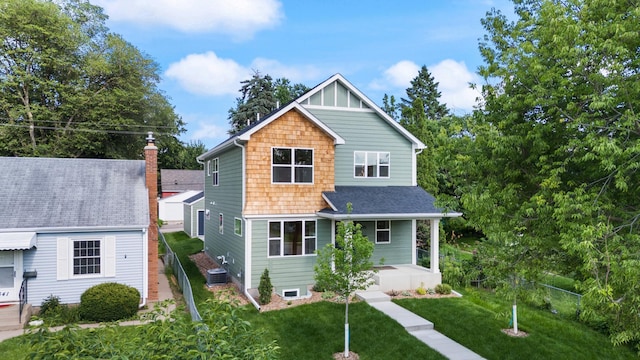 5345 45th Ave S, Minneapolis, MN 55417 - view of front of property with covered porch, a front lawn, a chimney, and roof with shingles