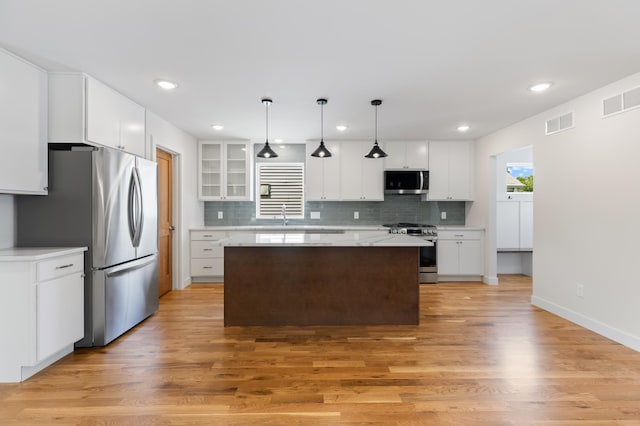 5345 45th Ave S, Minneapolis, MN 55417 - kitchen featuring appliances with stainless steel finishes, backsplash, light wood-style floors, and recessed lighting