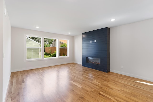 5345 45th Ave S, Minneapolis, MN 55417 - unfurnished living room featuring light wood-style floors, a large fireplace, and recessed lighting