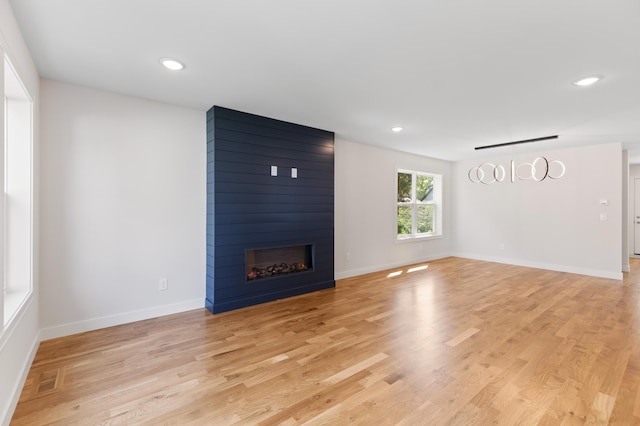 5345 45th Ave S, Minneapolis, MN 55417 - unfurnished living room featuring a large fireplace, light wood-style floors, and recessed lighting