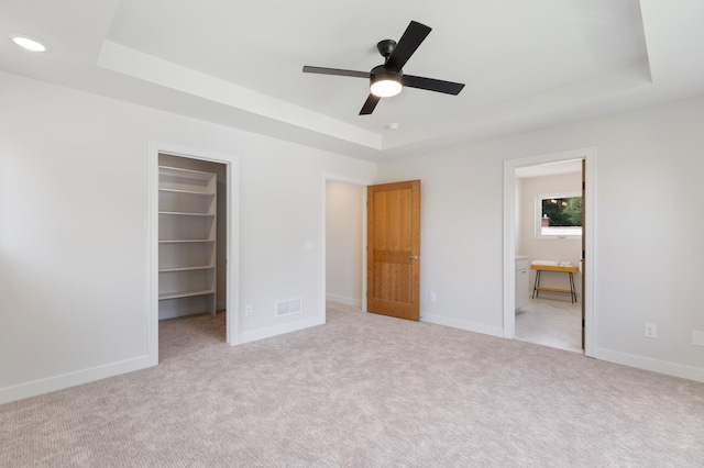 5345 45th Ave S, Minneapolis, MN 55417 - unfurnished bedroom with a tray ceiling, a walk in closet, carpet flooring, a closet, and ensuite bath
