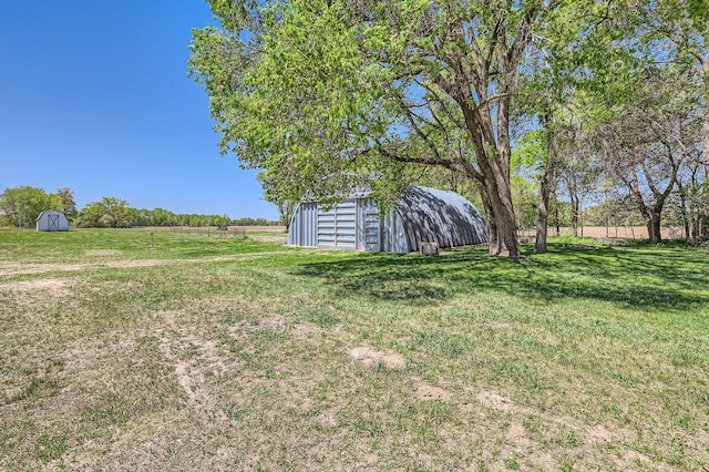 5159 Fawn Lake Dr NE, Linwood Twp, MN 55079 - view of green lawn with an outbuilding, a storage unit, and a view of countryside