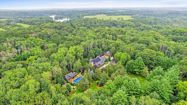 drone / aerial view featuring a wooded view