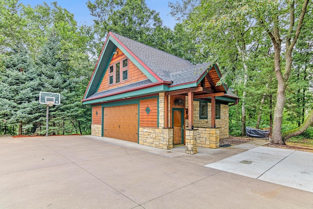 garage featuring a porch and driveway