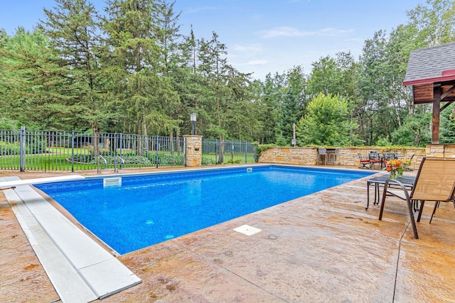view of pool featuring fence, a fenced in pool, and a patio