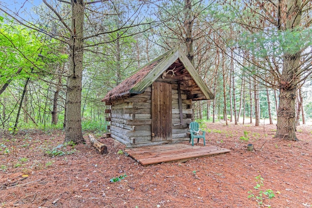view of shed featuring a view of trees