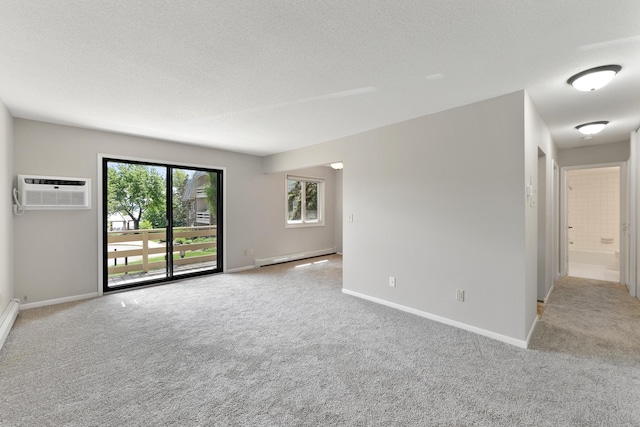 4387 Wilshire Blvd Unit 202, Mound, MN 55364 - empty room with a wall mounted air conditioner, baseboard heating, light carpet, baseboards, and a textured ceiling