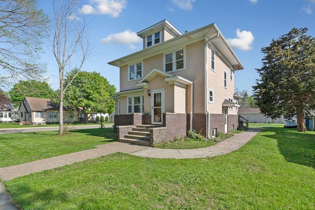 205 2nd St SW, Blooming Prairie, MN 55917 - traditional style home featuring stucco siding, a front yard, and brick siding