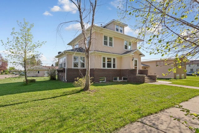 205 2nd St SW, Blooming Prairie, MN 55917 - american foursquare style home with a front lawn, stucco siding, and brick siding