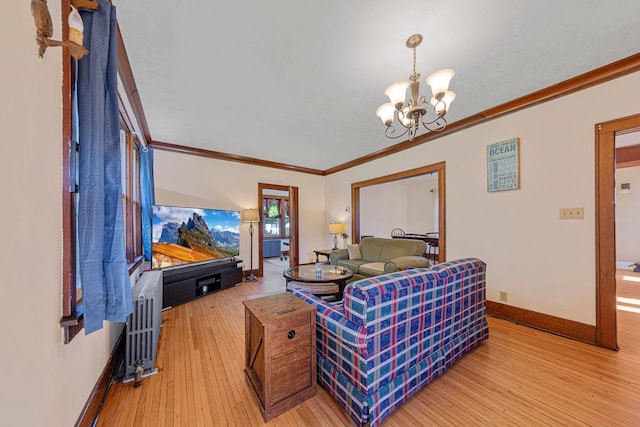 205 2nd St SW, Blooming Prairie, MN 55917 - living area with a chandelier, light wood-type flooring, ornamental molding, baseboards, and radiator heating unit