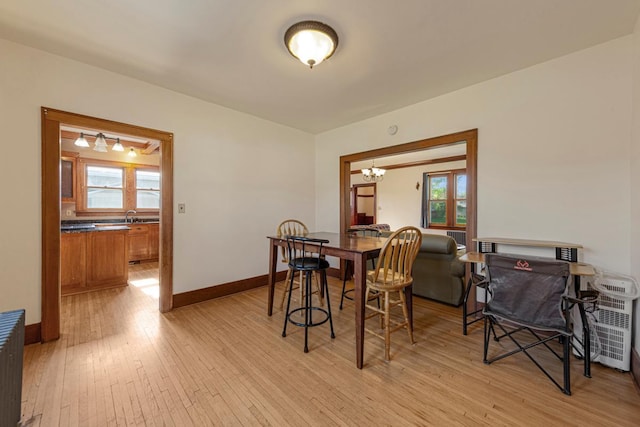 205 2nd St SW, Blooming Prairie, MN 55917 - dining room featuring light wood-style flooring, a chandelier, and baseboards
