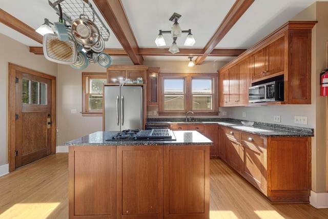 205 2nd St SW, Blooming Prairie, MN 55917 - kitchen with appliances with stainless steel finishes, light wood finished floors, beamed ceiling, a kitchen island, and dark stone counters