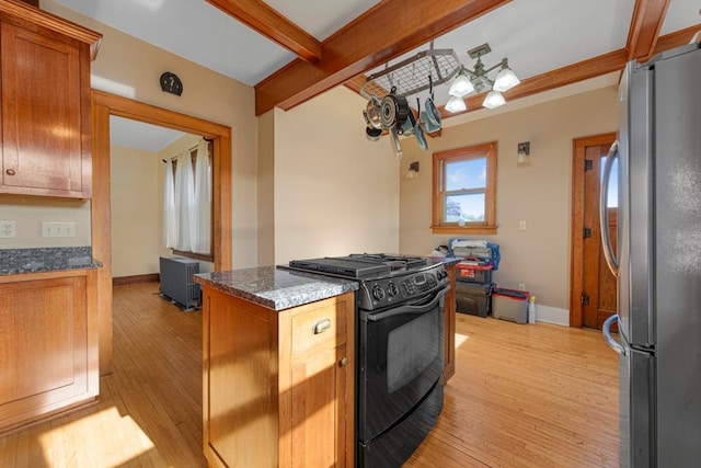205 2nd St SW, Blooming Prairie, MN 55917 - kitchen with gas stove, freestanding refrigerator, light wood-style flooring, baseboards, and beam ceiling