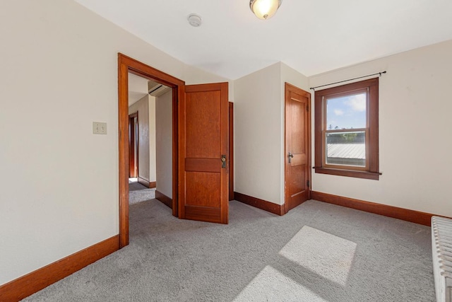 205 2nd St SW, Blooming Prairie, MN 55917 - empty room featuring light colored carpet, baseboards, and a smoke detector