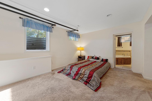 205 2nd St SW, Blooming Prairie, MN 55917 - bedroom with carpet floors, multiple windows, baseboards, ensuite bathroom, and recessed lighting