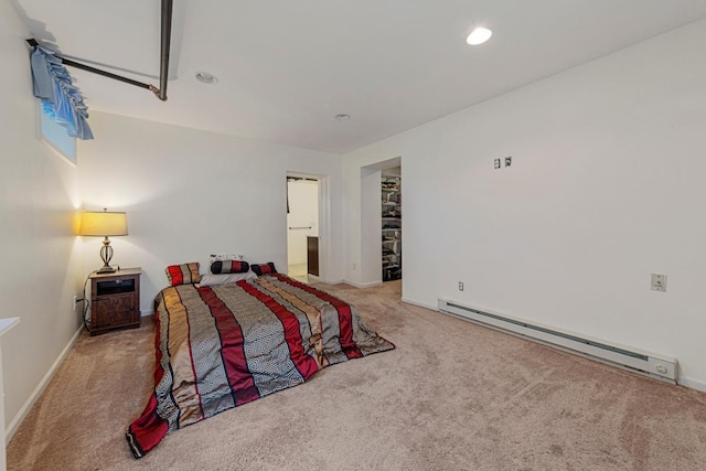 205 2nd St SW, Blooming Prairie, MN 55917 - bedroom featuring baseboard heating, carpet, a walk in closet, baseboards, and recessed lighting
