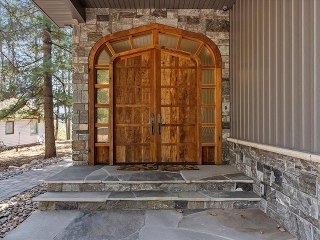 doorway to property with stone siding