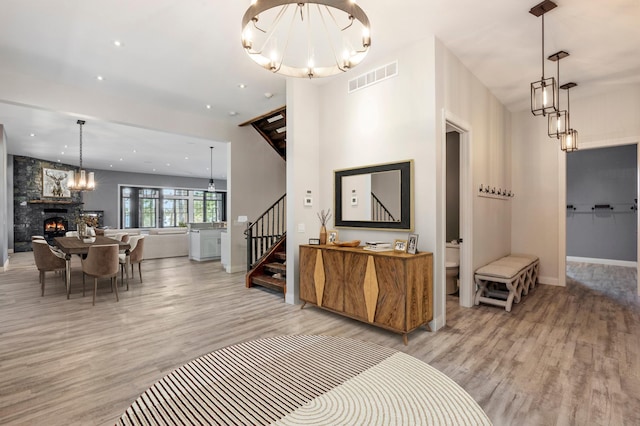 interior space featuring wood finished floors, stairs, baseboards, a chandelier, and recessed lighting