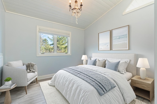 bedroom with lofted ceiling, baseboards, light wood-style floors, and wooden ceiling