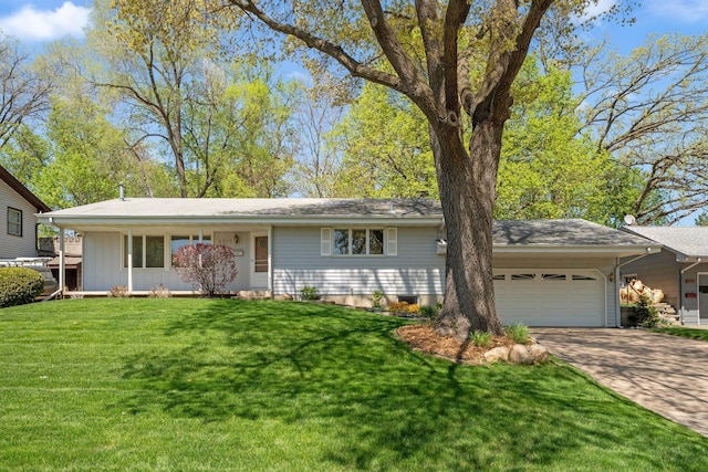 ranch-style house with a garage, concrete driveway, and a front lawn