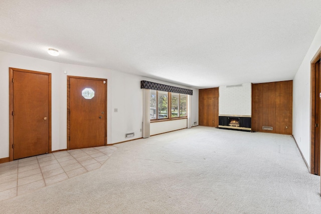 unfurnished living room with a fireplace, baseboards, and light carpet