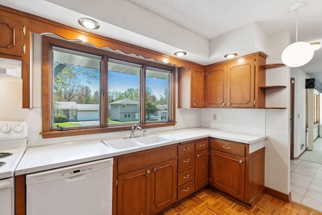 kitchen with white appliances, a sink, open shelves, brown cabinetry, and light countertops