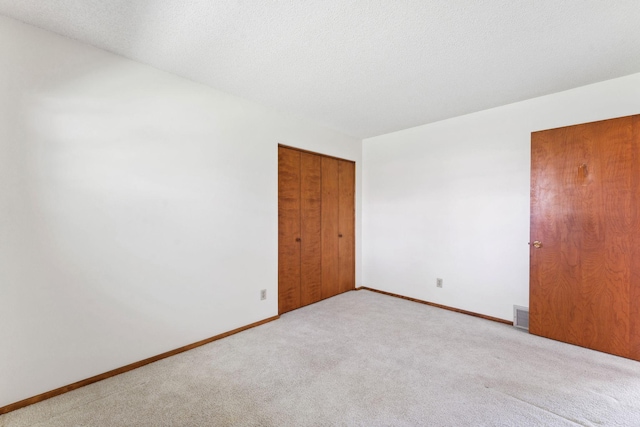spare room featuring carpet flooring and baseboards