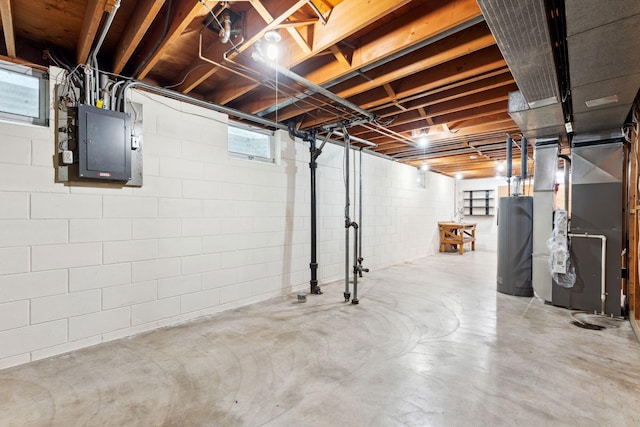 below grade area featuring water heater, electric panel, and heating unit