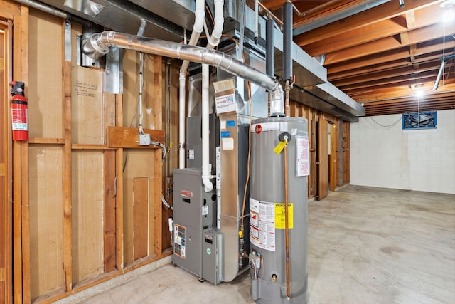unfinished basement with gas water heater, concrete block wall, and heating unit